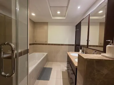 a bathroom with a tub and a sink at Vacay Lettings 1 bed with burj Khalifa View in Dubai
