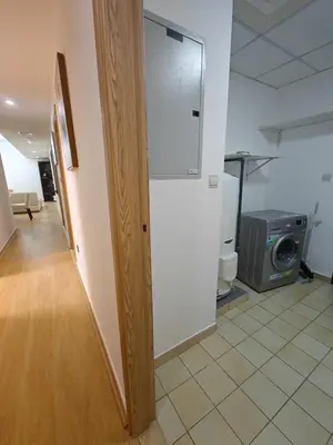 a door in a room with a kitchen with a microwave at 2 Massage Chairs Marina View 2 Bedrooms in Dubai