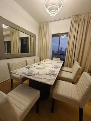 a dining room with a large table with white chairs at 2 Massage Chairs Marina View 2 Bedrooms in Dubai