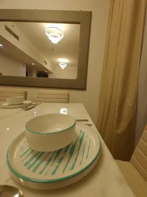 a bowl on a plate on a table at 2 Massage Chairs Marina View 2 Bedrooms in Dubai
