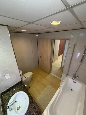 a bathroom with a tub and a sink and a toilet at 2 Massage Chairs Marina View 2 Bedrooms in Dubai
