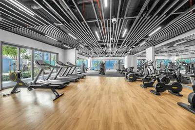 a gym with treadmills and elliptical machines at Gym, Spa & Sauna, Pool, Tenis Court, Dishwasher, 2BR in Central Park in Dubai