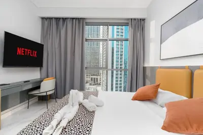 a hotel room with a large bed and a tv at Luxury 2BR Business Bay Balcony in Dubai