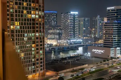 a view of a city at night with buildings at Luxury 2BR Business Bay Balcony in Dubai