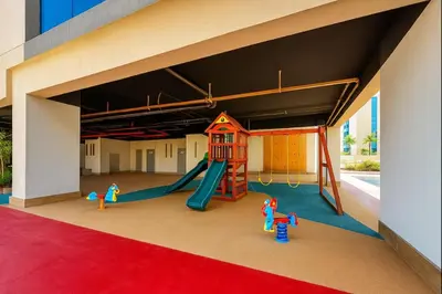 a play area with a slide and a playground at Vogue JVC Jeewar Tower Near Circle Mall, One Bedroom Apartment with Balcony and City View, Access to all Amenities in Dubai