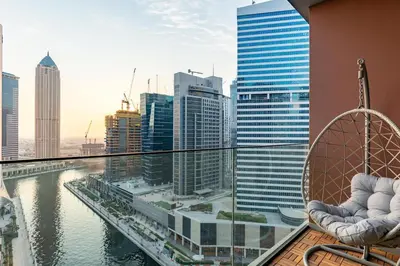 a balcony with chairs and a view of a city at Modern Studio Canal & Pool View Business Bay in Dubai
