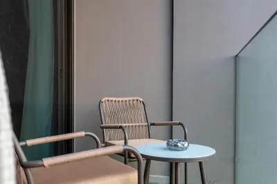 a chair and a table with a bowl on it at Modern Studio Canal & Pool View Business Bay in Dubai