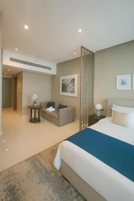 a hotel room with a bed and a couch at Opulent Suites - Business Bay - Downtown in Dubai