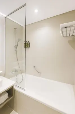 a bathroom with a shower with a glass door at Opulent Suites - Business Bay - Downtown in Dubai