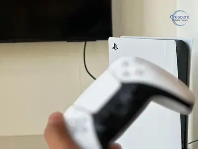 a person holding a nintendo wii remote control at Premium 1 Bedroom Stay in Berkeley Place in Dubai