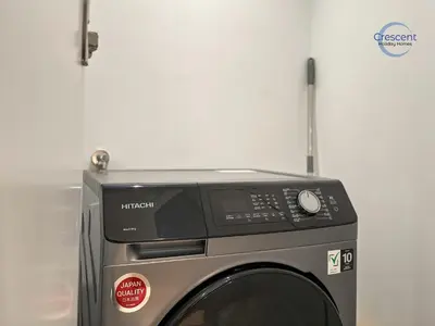 a microwave oven sitting on top of a washing machine at Premium 1 Bedroom Stay in Berkeley Place in Dubai