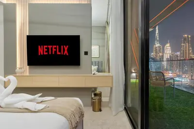 a hotel room with a television and a swan on a bed at Stylish 1BR Canal & Burj View High Floor in Dubai