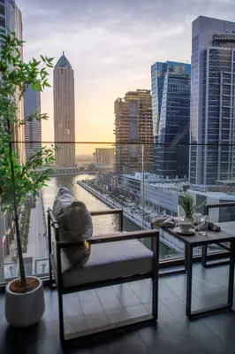 a balcony with a table and a view of a city at Frank Porter - Peninsula One in Dubai