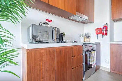 a kitchen with a microwave and a stove at Frank Porter - La Voile in Dubai