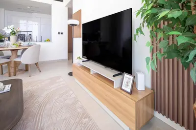 a living room with a large television on a wall at Frank Porter - Binghatti Onyx in Dubai