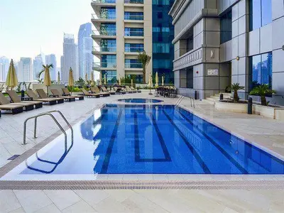a large blue swimming pool in a building at Sea View Luxe Room Marina Dubai in Dubai