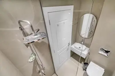 a bathroom with a sink and a toilet and a mirror at Sadaf 2701 in Dubai