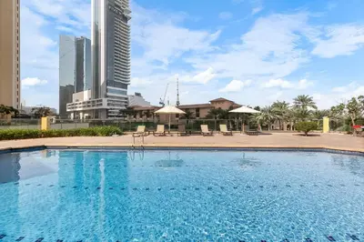 a large swimming pool with buildings in the background at Sadaf 2701 in Dubai