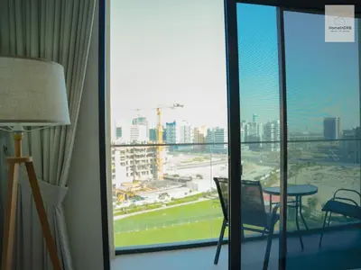 a room with a window with a view of a tennis court at Elegant Haven by Meraki - New 1 Bed Garden View in Dubai