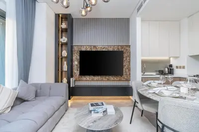 a living room with a couch and a table at 2 Apt Combo Studio And 1BR Same Tower Canal View in Dubai