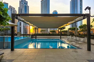 a swimming pool in a city with tall buildings at Burj Khalifa Doorstep Stunning 2BR Apartment in Dubai