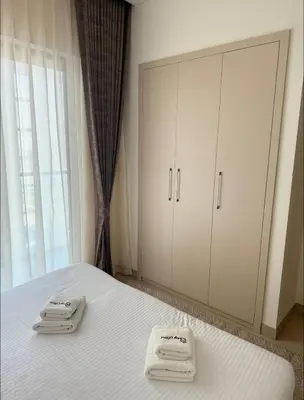 a bedroom with a bed with two towels on it at Holiday heaven specious one bed room apartment near Dubai mall with burj khalifa view in Dubai