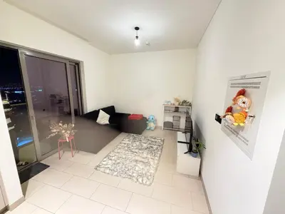 a living room with a large window and a white floor at Holiday heaven specious one bed room apartment near Dubai mall with burj khalifa view in Dubai