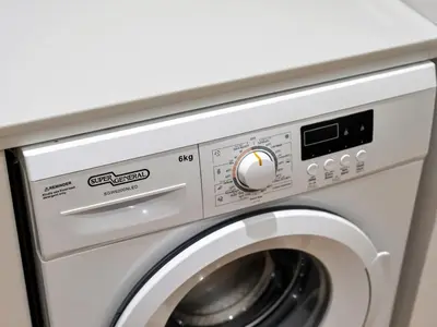 a white washer and dryer in a room at JBR Studio - Steps to Beach & Marina Walk - Pool & Gym in Dubai