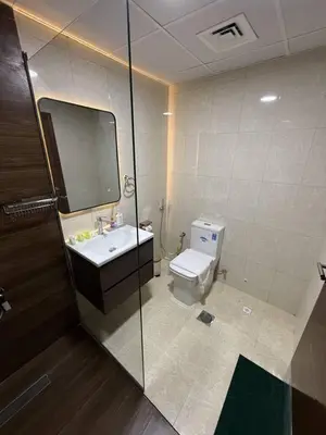 a bathroom with a toilet and a sink and a mirror at Aesthetic Feel with Lake View in Dubai
