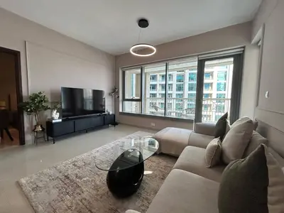 a living room with a couch and a tv at Luxurious 1Bedroom Apt in 29 Boulevard - Downtown in Dubai