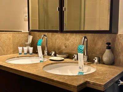 a bathroom counter with two sinks and a mirror at Luxurious 1Bedroom Apt in 29 Boulevard - Downtown in Dubai