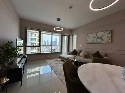 a living room with a couch and a table at Luxurious 1Bedroom Apt in 29 Boulevard - Downtown in Dubai