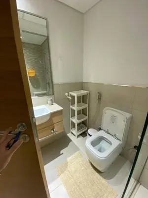 a small bathroom with a toilet and a sink at Bright and Stylish Studio - Azizi Aura in Dubai