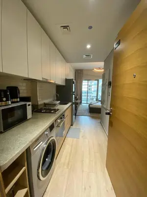 a kitchen with a washer and dryer in it at Bright and Stylish Studio - Azizi Aura in Dubai