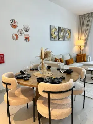 a dining room with a table and chairs at Comfortable one bed - Gym and Parking in Dubai