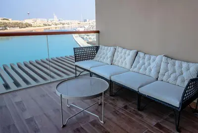 a living room with a couch and two chairs and a table at Stylish Studio Apt in Palm Views East PalmJumeirah in Dubai