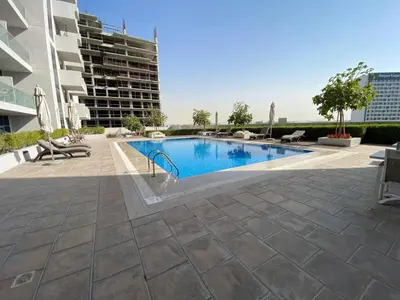 a swimming pool in the middle of a building at Furnished studio apartment next to metro in Dubai
