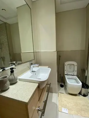 a bathroom with a sink and a toilet at Furnished studio apartment next to metro in Dubai