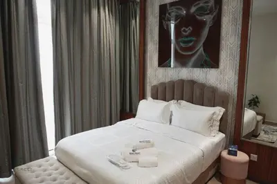 a bedroom with a large bed with towels on it at Luxurious 3 BR Apt in Park Gate Residences in Dubai