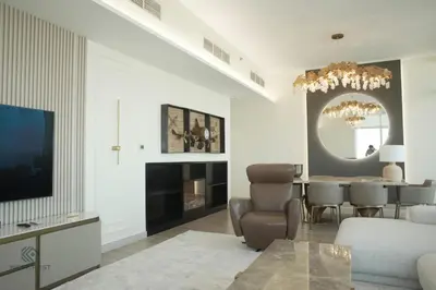 a living room with a table and a dining room at Luxurious 3 BR Apt in Park Gate Residences in Dubai