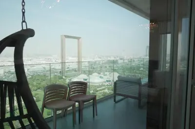 a balcony with chairs and a view of a city at Luxurious 3 BR Apt in Park Gate Residences in Dubai