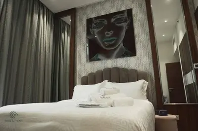 a bedroom with a large bed with towels on it at Luxurious 3 BR Apt in Park Gate Residences in Dubai