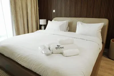 a bed with towels on top of it at Luxurious 3 BR Apt in Park Gate Residences in Dubai