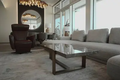 a living room with a couch and a glass coffee table at Luxurious 3 BR Apt in Park Gate Residences in Dubai