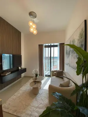 a living room with a couch and a tv at Cozy 1 Bedroom Apartment near Downtown in Dubai