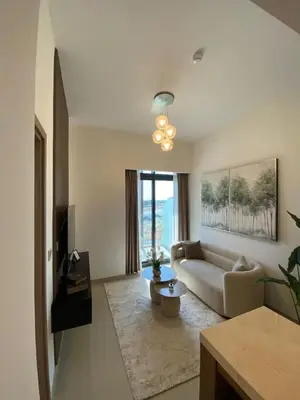 a living room with a couch and a table at Cozy 1 Bedroom Apartment near Downtown in Dubai