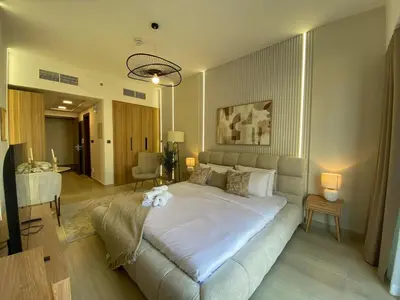 a bedroom with a large bed in a room at Cozy Studio Apartment with Balcony in Dubai