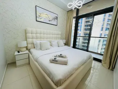 a bedroom with a large bed and a large window at Modern 2bhk Apartment with Stunning City Views in Dubai