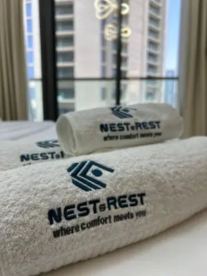 two towels on a bed in a hotel room at Modern 2bhk Apartment with Stunning City Views in Dubai
