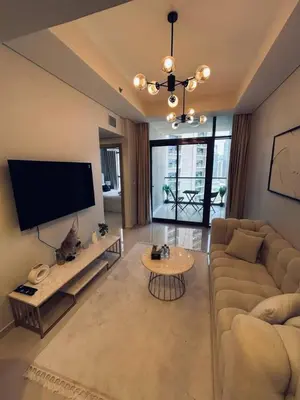a living room with a couch and a tv at Modern 2bhk Apartment with Stunning City Views in Dubai